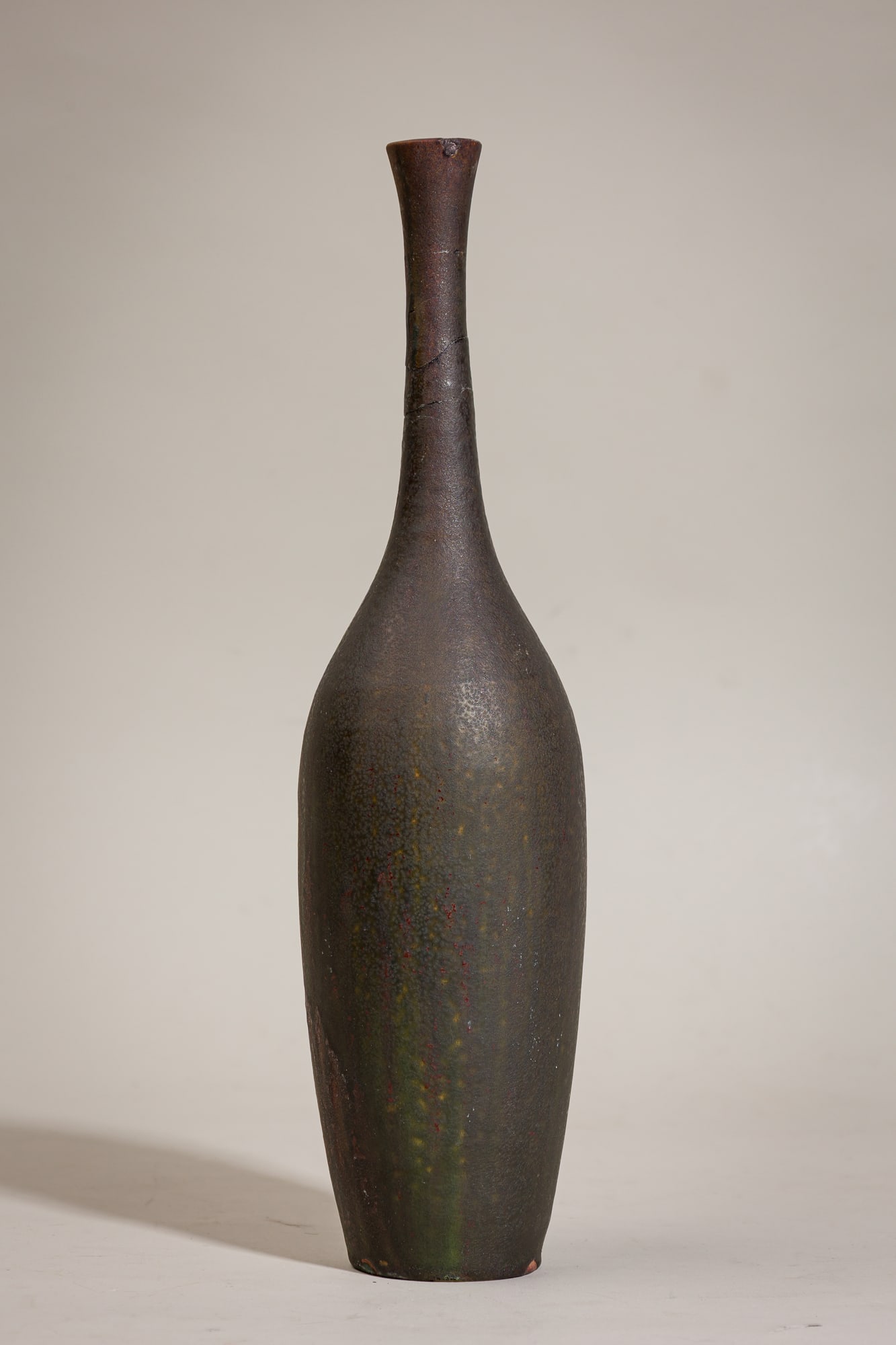Suzanne Ramie Long Neck Bottle Vase: c. 1950, France, mottled greens, purples and brown glazed pottery, for Atelier Madoura, marked "Madura" on underside, 14.75"h x 4"diaProvenance: 118 E. 87th St, NYC: A Private