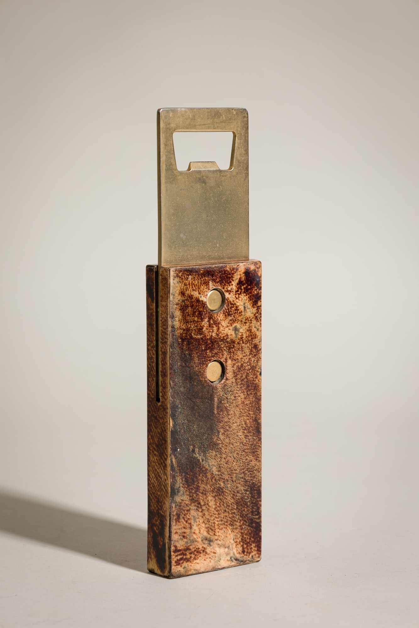 Aldo Tura, Oversized Brass and Parchment Bottle Opener: c. 1960s, Italy, brown-dyed goatskin over wood, polished brass with golden patina, unmarked, 9"h x 2.5"w x .75"d Provenance: 118 E. 87th St, NYC: A Private Collection featuring&nbs
