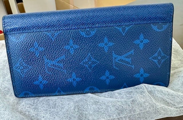 Louis Vuitton Taigarama Portefeuille Brazza Wallet: Brand: Louis VuittonModel: Portefeuille brazzaMaterial: Monogram coated canvas and matching Taiga cowhide leatherColor: BlueDate Code: RFID France or SpainApprox. Dimensions: 7.5" L x 3.9" H x 0.7"