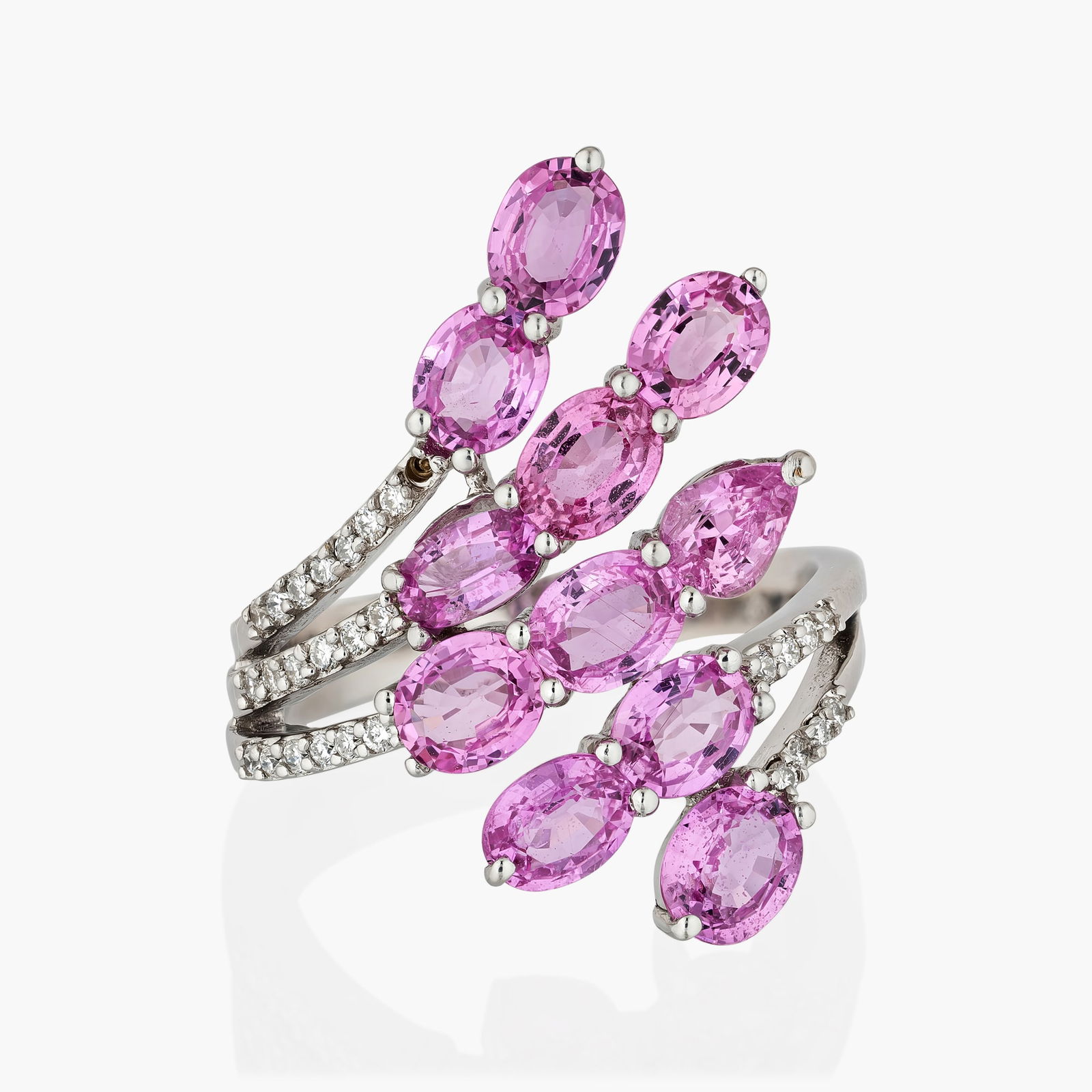 Pink Sapphire And Diamond Ring: Origin: ContemporaryMetal: 18K white goldGemstones: Oval shape pink sapphire approx. 6.00 carats total: Round brilliant cut diamonds approx.0.25 carats totalMeasurements: 1 inch longRing size: