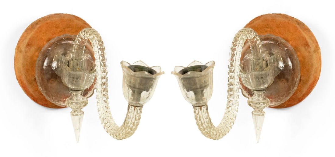 Pair of English Victorian Waterford crystal wall sconces: 19th/20th c., England, clear glass. the rope-twist scroll arm issuing form a domed backplate, 10" h x 6"w x 14.5"d