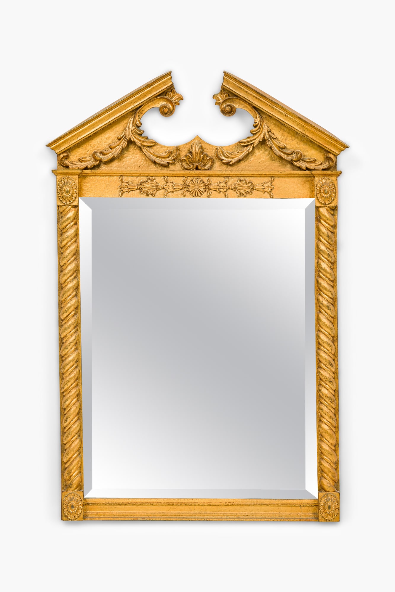 George II style giltwood mirror: mid-20th c., USA, gold finished carved wood, with broken pediment crest, the beveled mirror glass flanked by twisting pilasters, Interiors, Inc label verso, 40"h x 27"wProvenance: 465 Park Ave