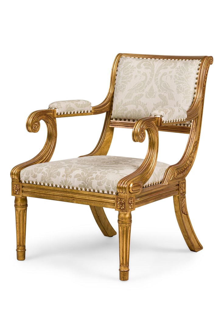 English Regency style giltwood and damask armchair: 20th c., England, carved gilt wood frame with scroll armrests, upholstered in a grey damask with brass nailheads, resting on two fluted front legs and 2 splayed back legs 35.25"h x 25"w x 31"d, 17"h (