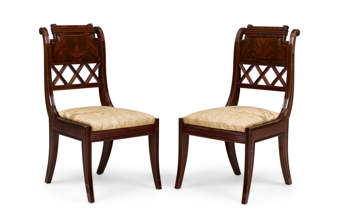 Pair French Directoire style mahogany side chairs: 20th c., France, carved mahogany frames with an open diamond back design, gold damask cushioned seat, resting on four sabre legs, 37.5"h x 20"w x 23"d, 18"h (to seat)