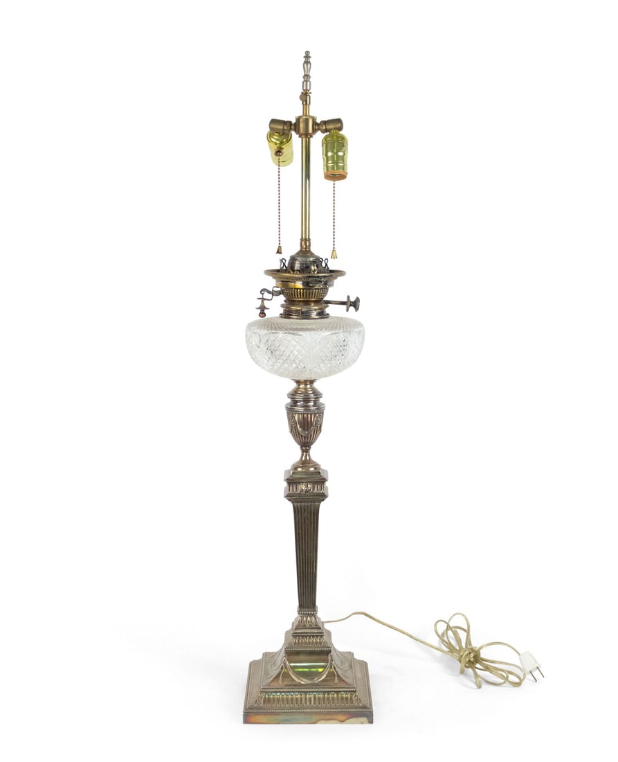 English Victorian silver-plated electrified oil lamp: 19th c. and adapted, George II silver plate column table lamp with urn design and cut crystal font, mounted with later brass rod topped with double cluster socket, 36" h (to finial)