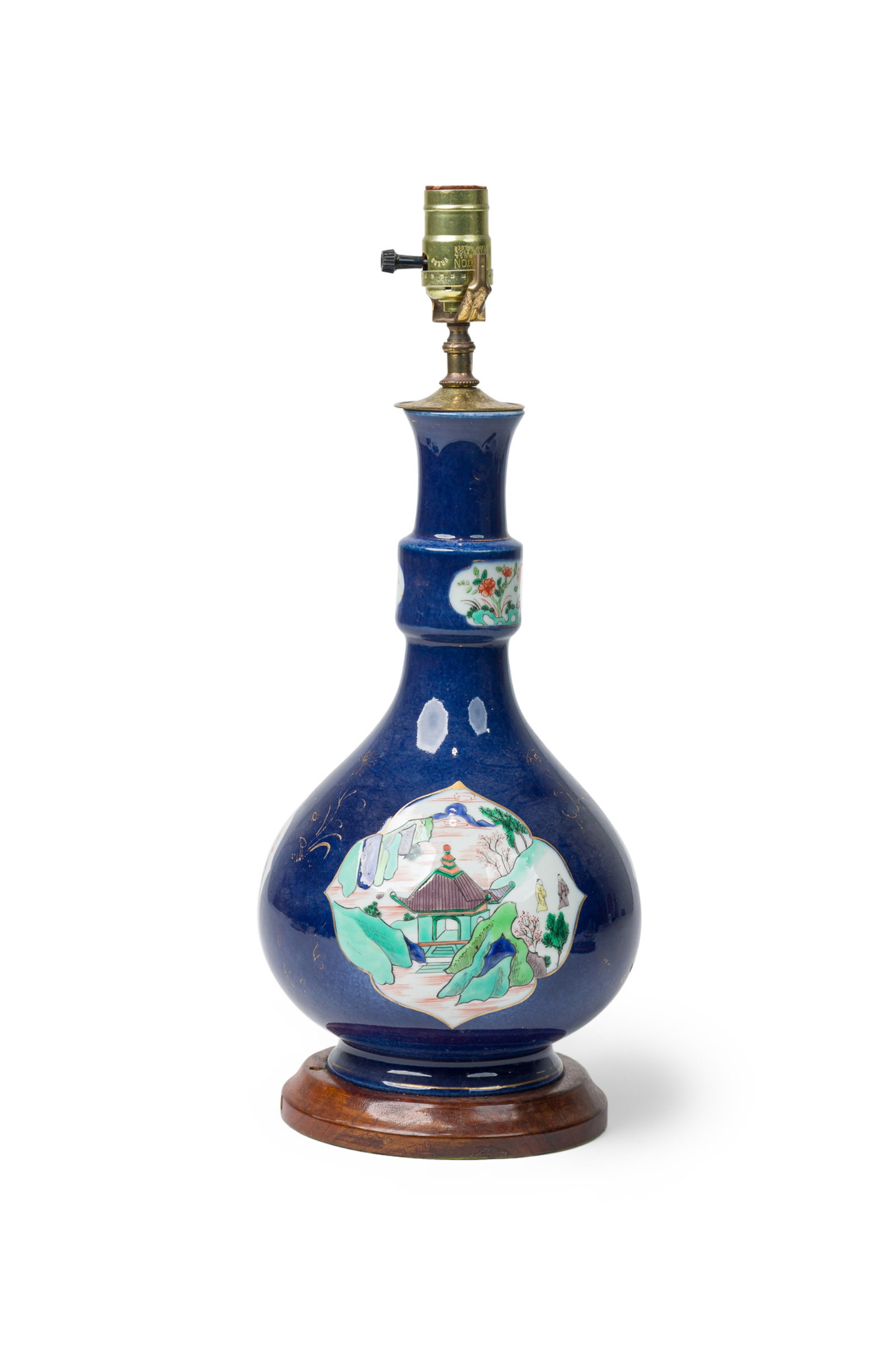 Chinese Export cobalt blue and famille verte porcelain table lamp: PRC Period (mid-20th c.), China, gilt and polychrome enamels on blue glazed porcelain, the Kangxi style bottle vase decorated with landscape panels, on wooden base with a brass stem, 19" h x 8"w x 8"d