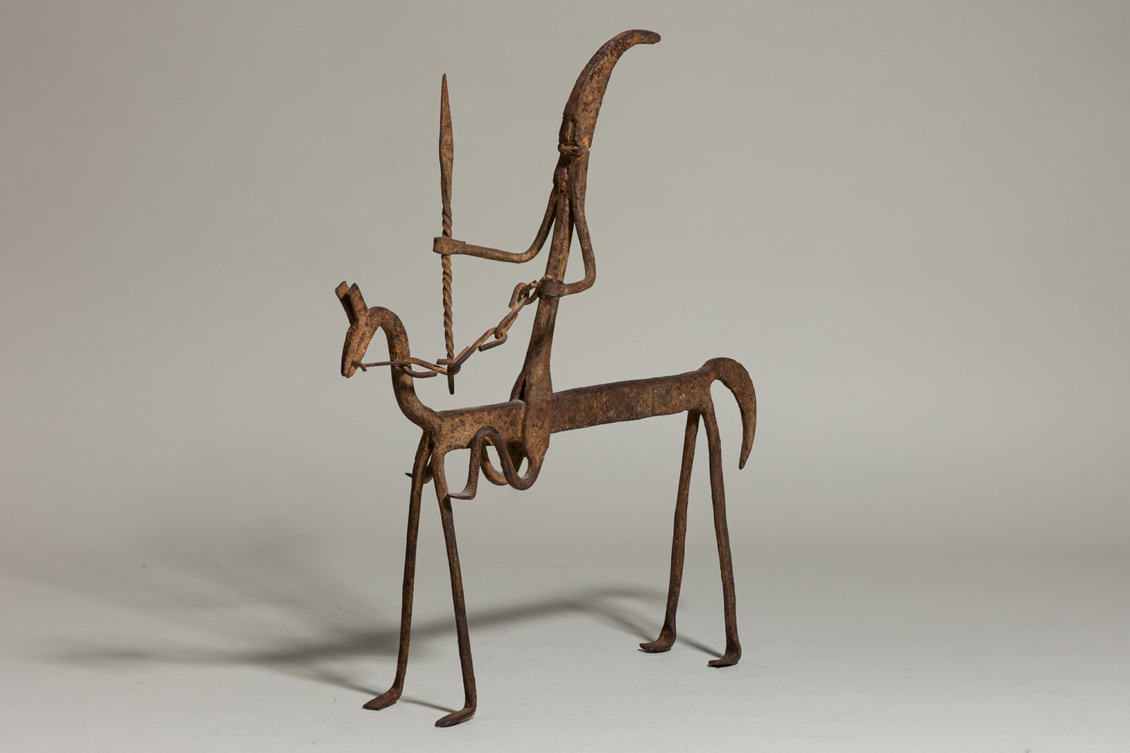 Dogon Bronze Horse and Rider: 20th c, Mali, wrought iron, depicted holding a spear 14.5"h x 13"w x 5"dProvenance: 118 E. 87th St, NYC: A Private Collection featuring Ancient, Native American, and Modern Pottery