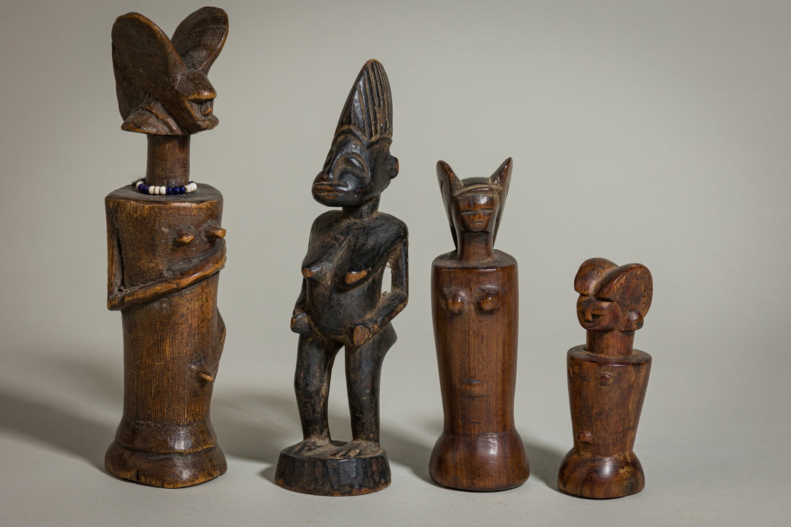 (4) Nyamwezi Mwana Hiti miniature wood figures: 19th/20th c., Tanzania, carved wood with patina, 7.5"h (largest), 4"h (smallest)Provenance: Property from 2 Gramercy Park, NYC