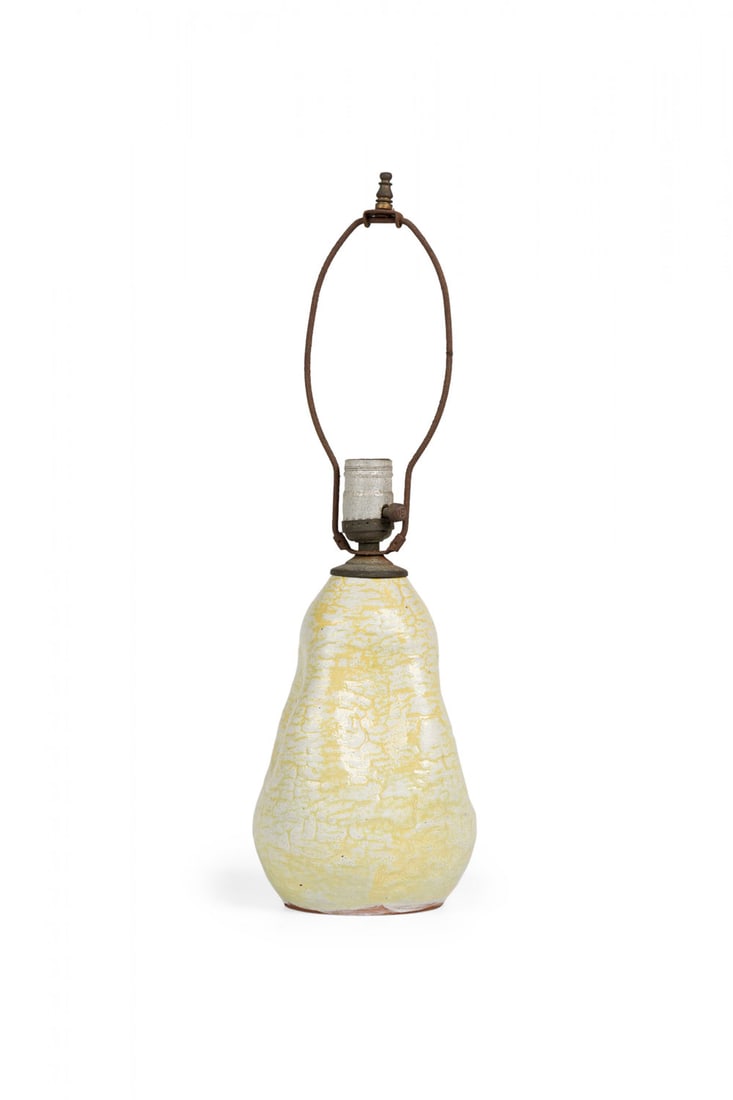 Organic Modern glazed ceramic table lamp: c. 1950s, USA, yellow and white texture glazed ceramic table lamp, of pinched teardrop form, metal cap, harp, finial and nonfunctioning light switch socket, 12" h x 6"dia