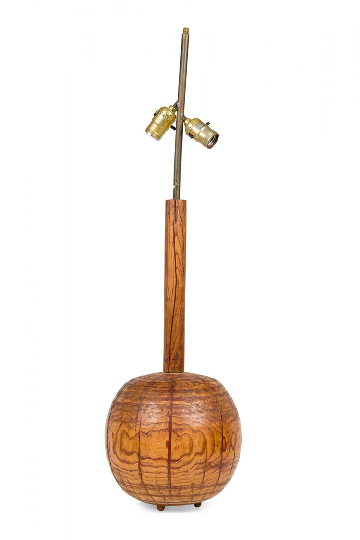 American Studio Craft carved Palm Wood Sphere Form Table Lamp: Mid 20th c., turned hardwood, the spherical body composed of inlaid wedges, issuing long dowel stem topped with brass rod mounted with two sockets, 33.25" h x 9"dia (to finial)