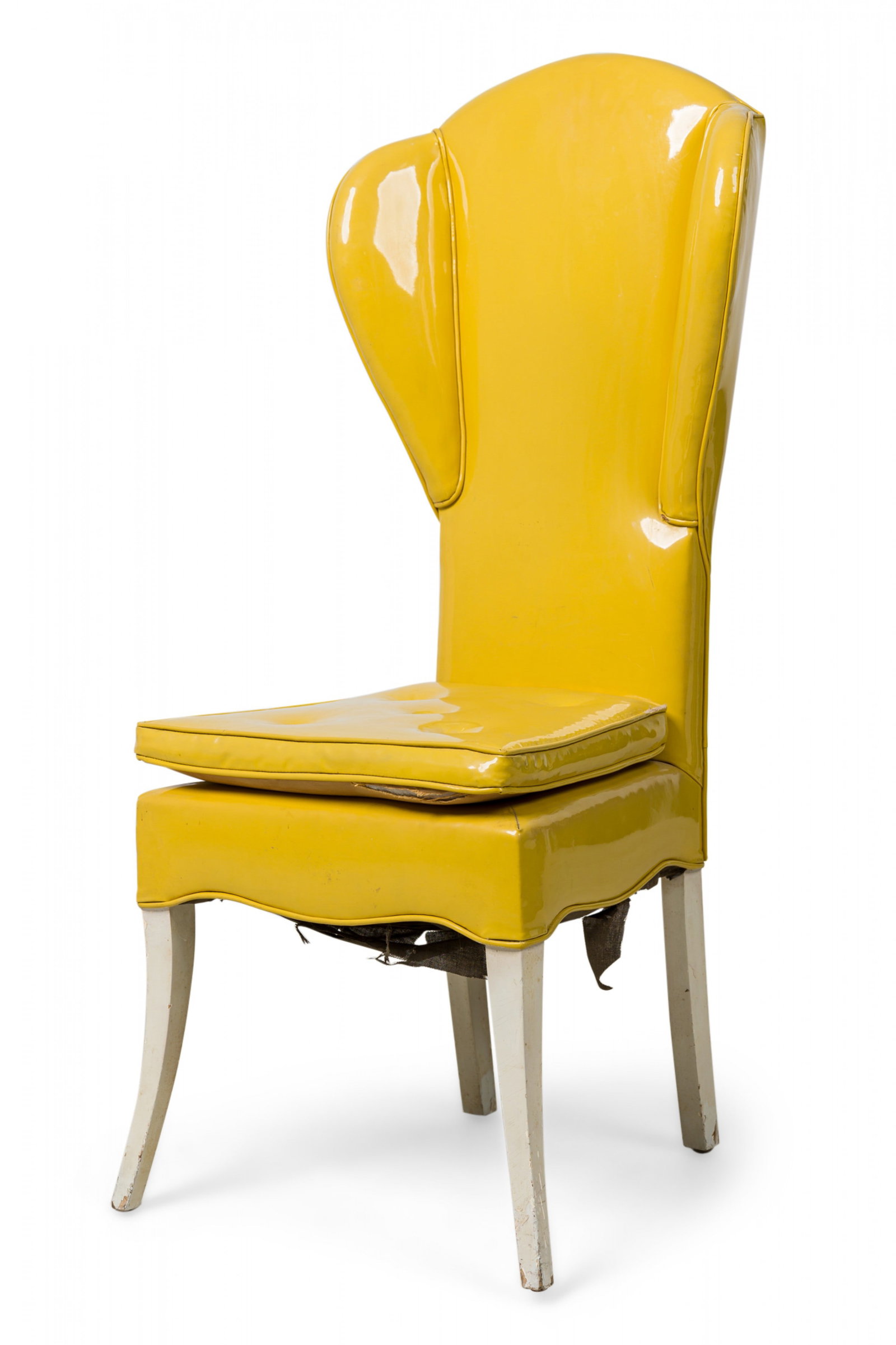 Tommi Parzinger, vinyl upholstered wing chair: c. 1960s, narrow wingback chair, padded and upholstered in glossy yellow vinyl, square seat cushion with button, shaped apron, resting on four white painted splayed legs, 48"h x 20"w x 19"d, 19"h (to 