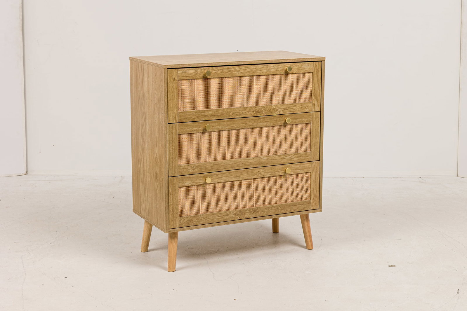 Contemporary 3-drawer wood and rattan dresser: 21st century., USA, particle board with oak finish, cube shaped cabinet with three drawers, drawers feature rattan panels and metal pulls, resting on four tapered oak legs, 36.25"h x 31.5"w x 15.75"dP