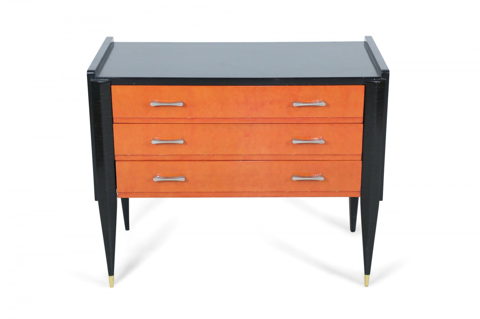 Continental Art Deco style 3-drawer commode: 20th c., possibly France, black and orange lacquered chest of drawers, the drawer fronts mounted with with nickel pulls, raised on triangular tapering legs ending in bronze sabots, 31" h x 39"w x 20.5