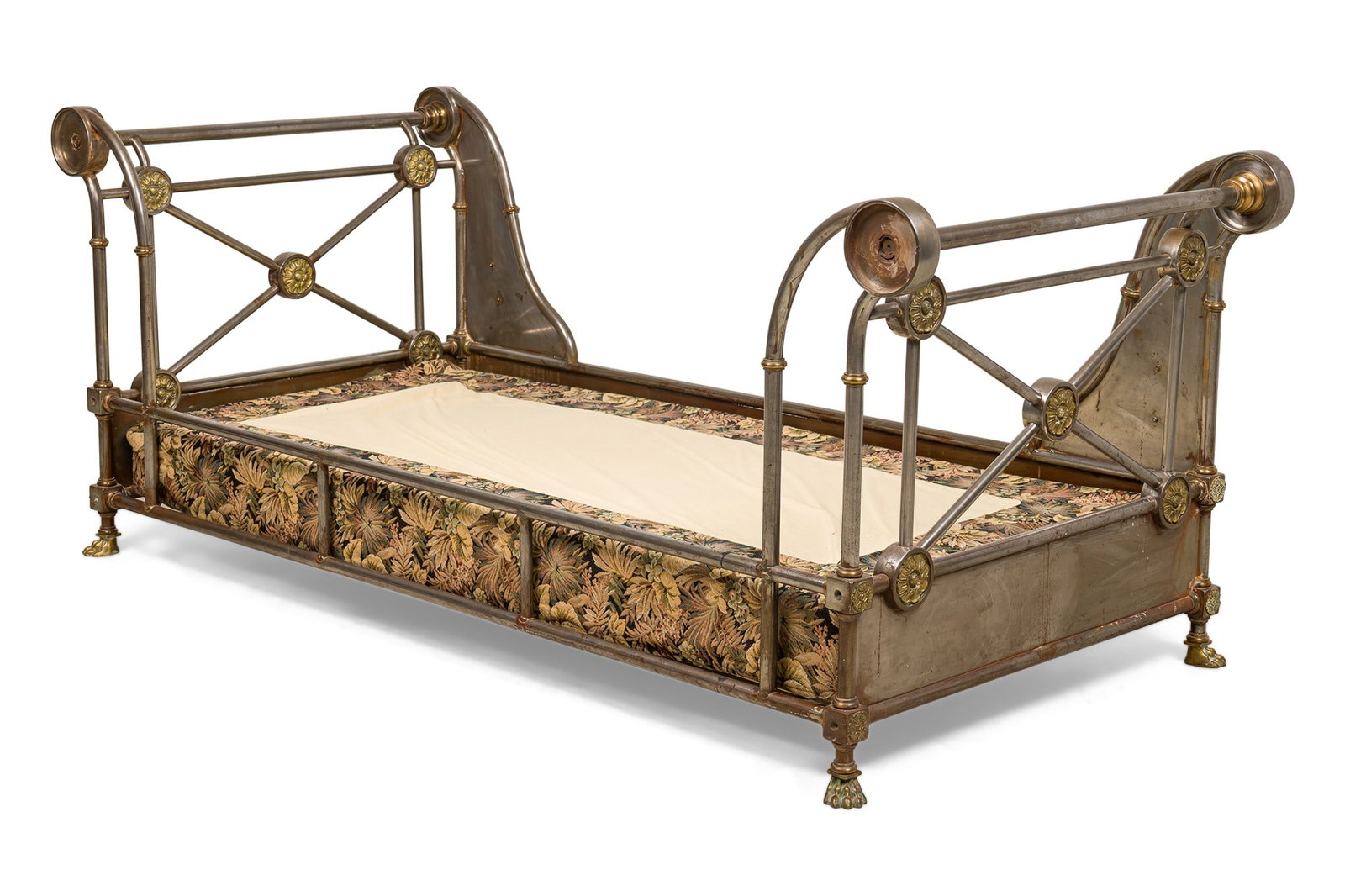 French Empire steel and bronze daybed: 19th c., France, steel and bronze trimmed rectangular sleigh-style frame with ornate rosette-carved corner blocks and winged maiden metal applique, inset mattress pad, resting on four bronze