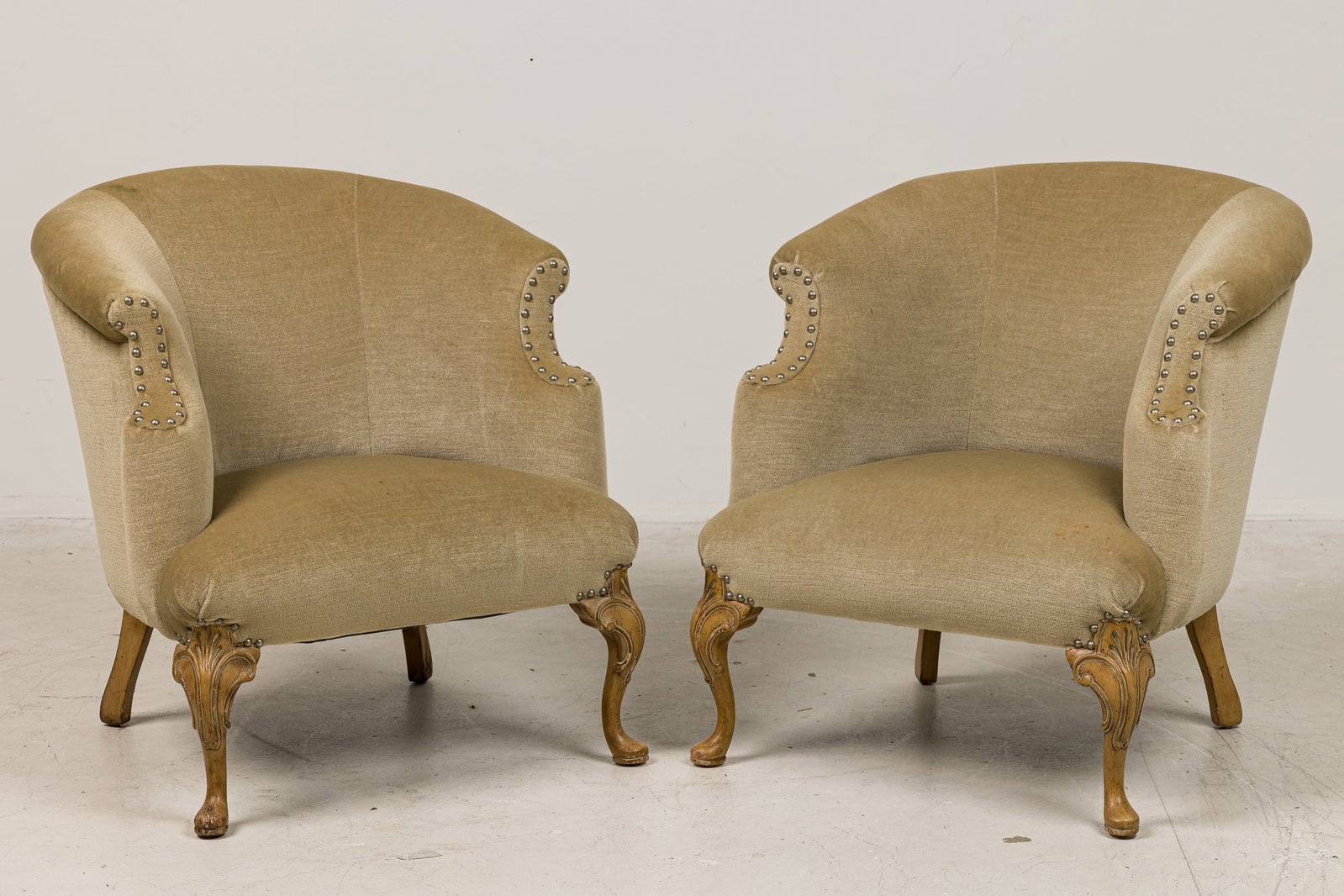 Pair Louis XVI style beechwood bergere armchairs, Mac II: 19th/20th century., France, rounded barrel-back form, upholstered in beige mohair with a nailhead trim, resting on four curved bleached wooden legs, placed by Mac II, 28"h x 25"w x 21"d