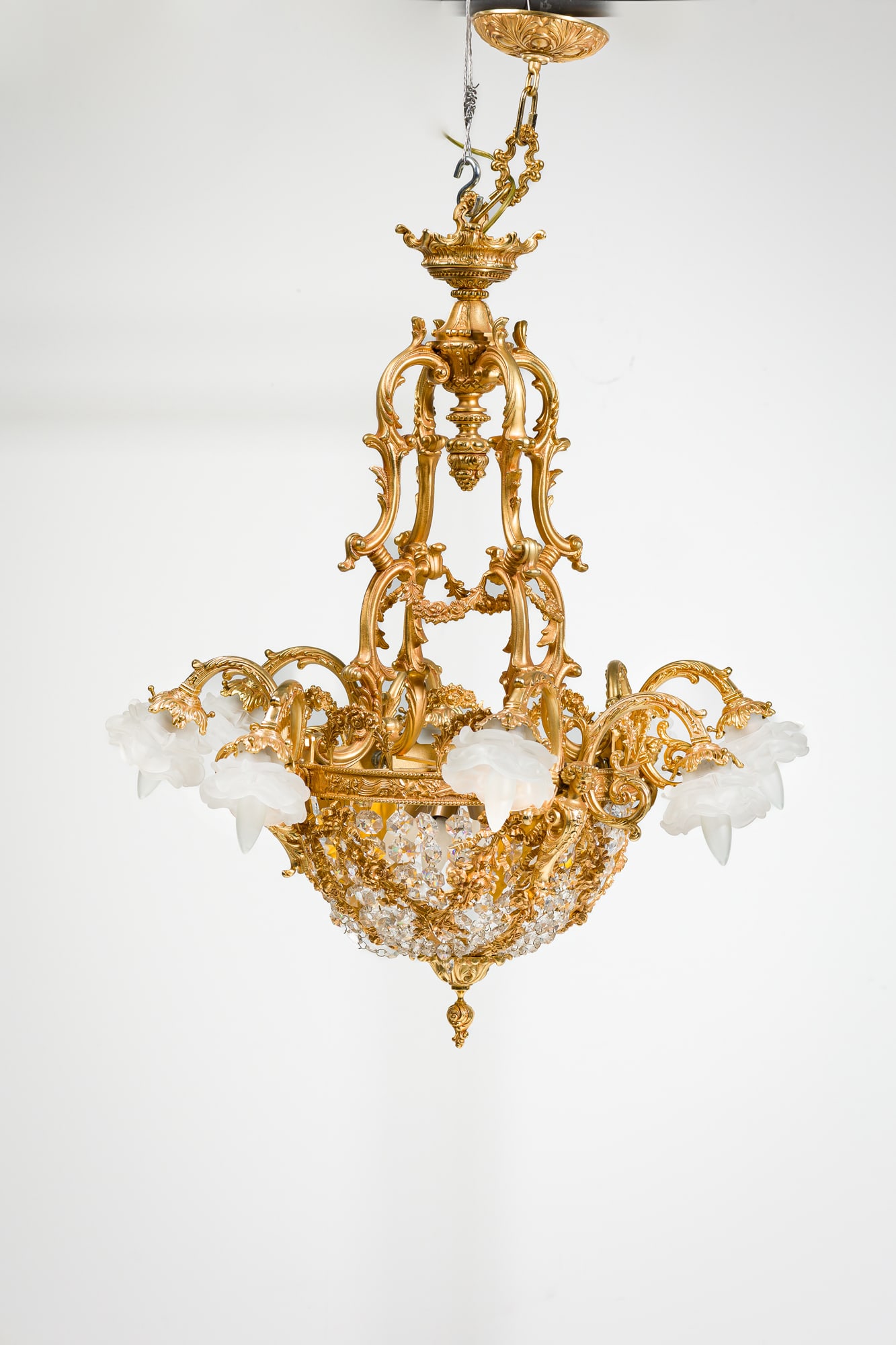 Louis XVI style gilt bronze 8-arm chandelier: 20th c., Italy, nicely cast and thickly gilt bronze, the basket decorated with floral swags and stung faceted crystals, the rim mounted with caryatids issuing eight foliate arms ending in frosted glas