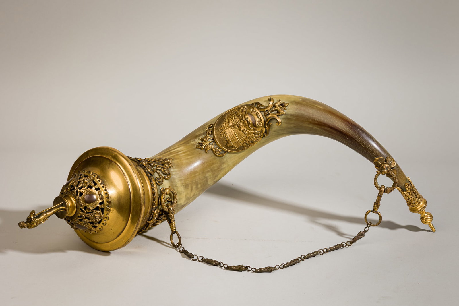 Large gilt bronze mounted ceremonial drinking horn, ex-Diana Vreeland: 19th c., likely Germany, highland cattle horn with gilt bronze mount depicting a architectural scene and a figural top, 21.5"h x 7"dia. Provenance: "Property from the estate of Diana D.