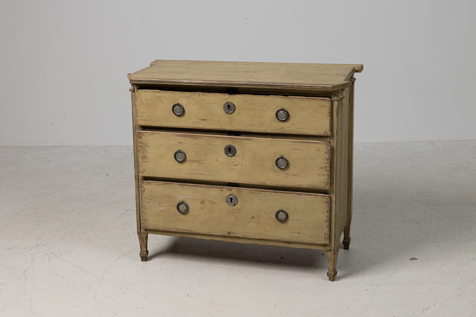 Swedish Gustavian chest of drawers, Thierry Despont: 19th c., Sweden, green painted pine, molded edge top with chamfered corners above three drawers with tinned-metal pulls, resting on four square legs, 32.5"h x 36.5"w x 17.5"d Provenance