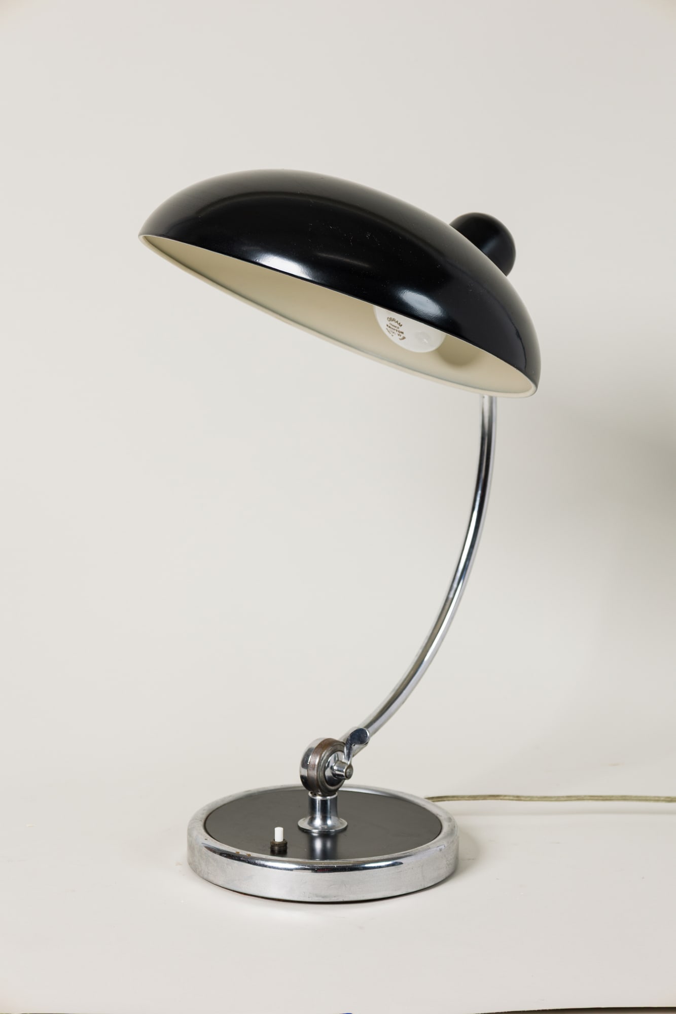 Christian Dell, table lamp, model 6331, Thierry Despont: introduced 1936, Germany, black lacquered steel shade, chrome-plated brass stem, molded manufacturer's mark to shade "Original Kaiser-Idell", 19.5"h x 13.25"dia. Provenance: Pr