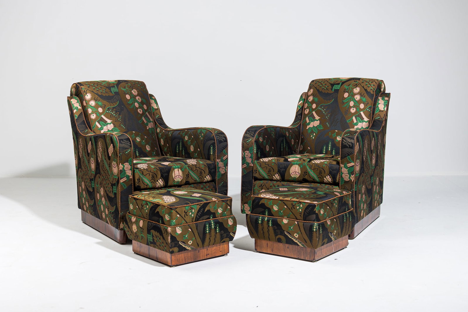 Italian Art Deco pair easy chairs and ottomans in custom Bizarre silk: c.1930s, Italy, rosewood veneered sleigh legs, fully upholstered seat with outward rolling back and arms, upholstered in a Stephen Bastone commission custom Prelle woven silk and metallic thread 