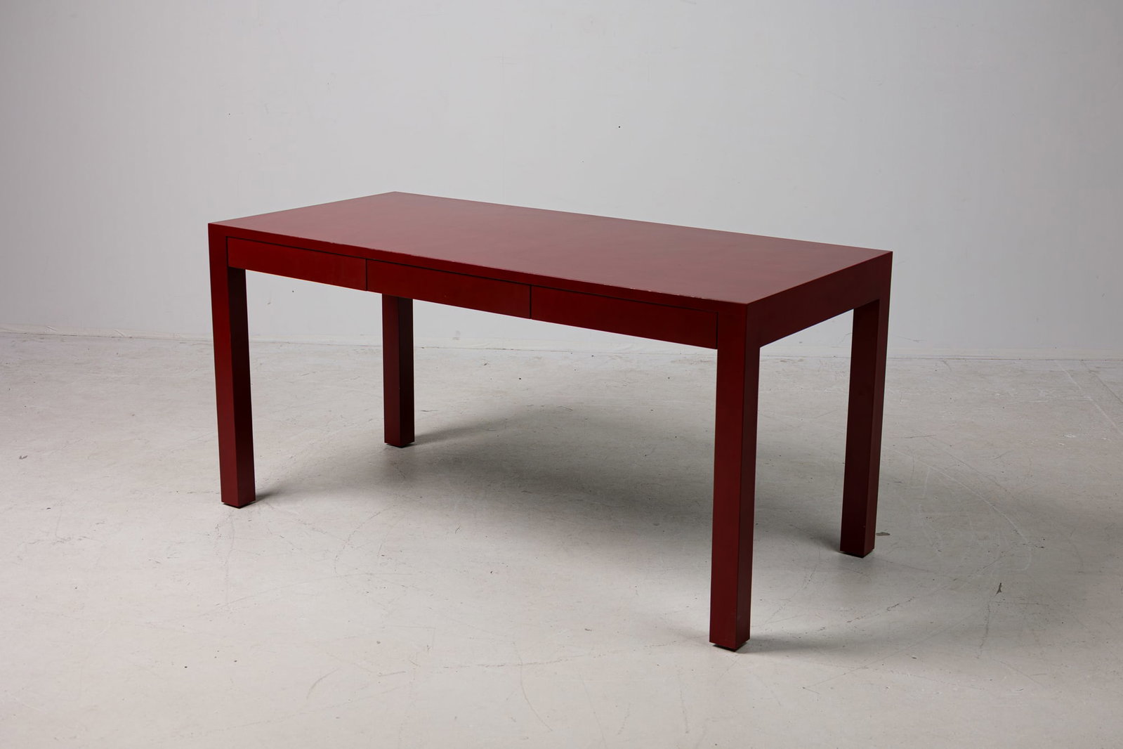 Thierry Despont, custom red lacquered parsons desk: late 20th c., USA, Oxblood painted wood, rectangular shaped top, over three frieze drawers, resting on four thick square legs, very nice construction, 29"h x 60"w x 28"d Prov
