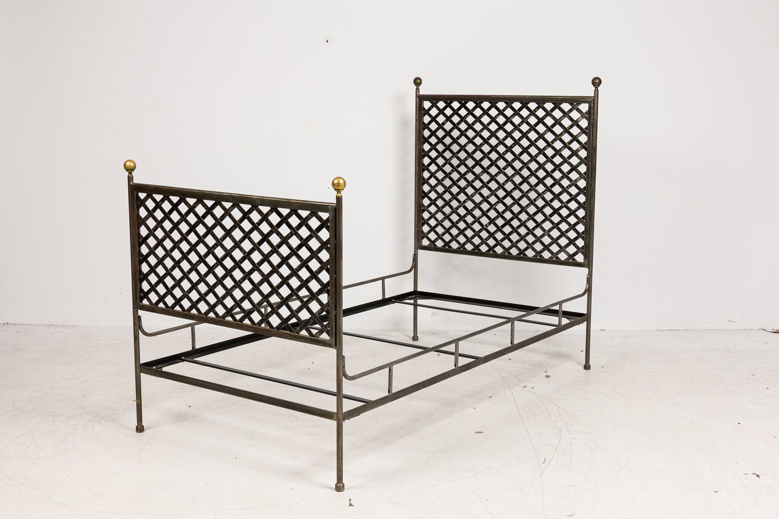Wrought iron lattice single bed frame: late 20th/21st c., USA, wrought iron headboard and footboard with lattice design and gilt finials, includes side rails, 57"h x 42"w x 80.5"d Property from 820 5th Ave: a Thierry Despont