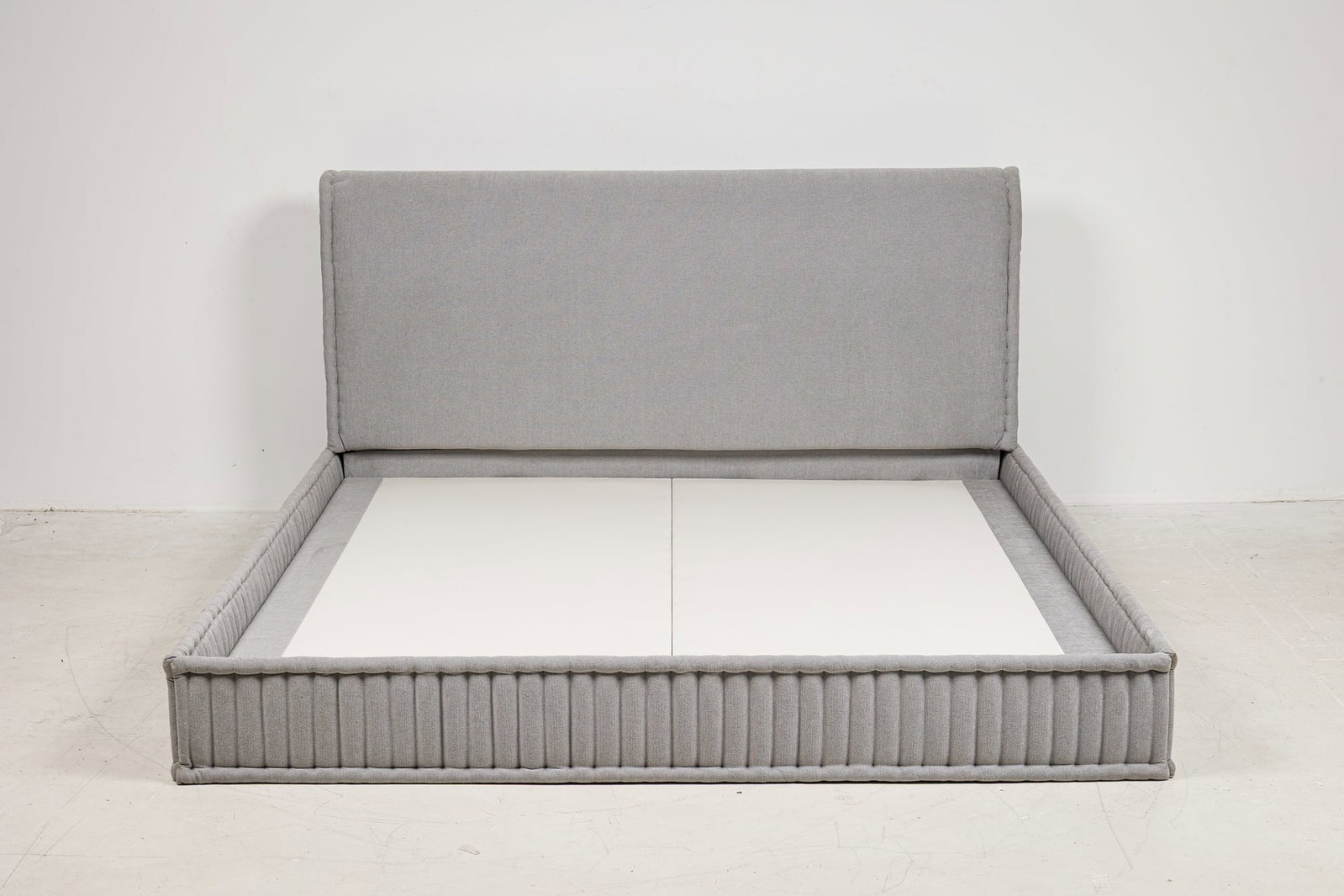 Dmitriy &. Co., custom king size bed frame,Thierry Despont: 20th c., USA, sleigh style frame, fully upholstered in grey velvet, with channeled side rails, Dmitriy &. Co. label on platform, designed or commissioned by Thierry Despont, 42.5"h x 79.75&qu