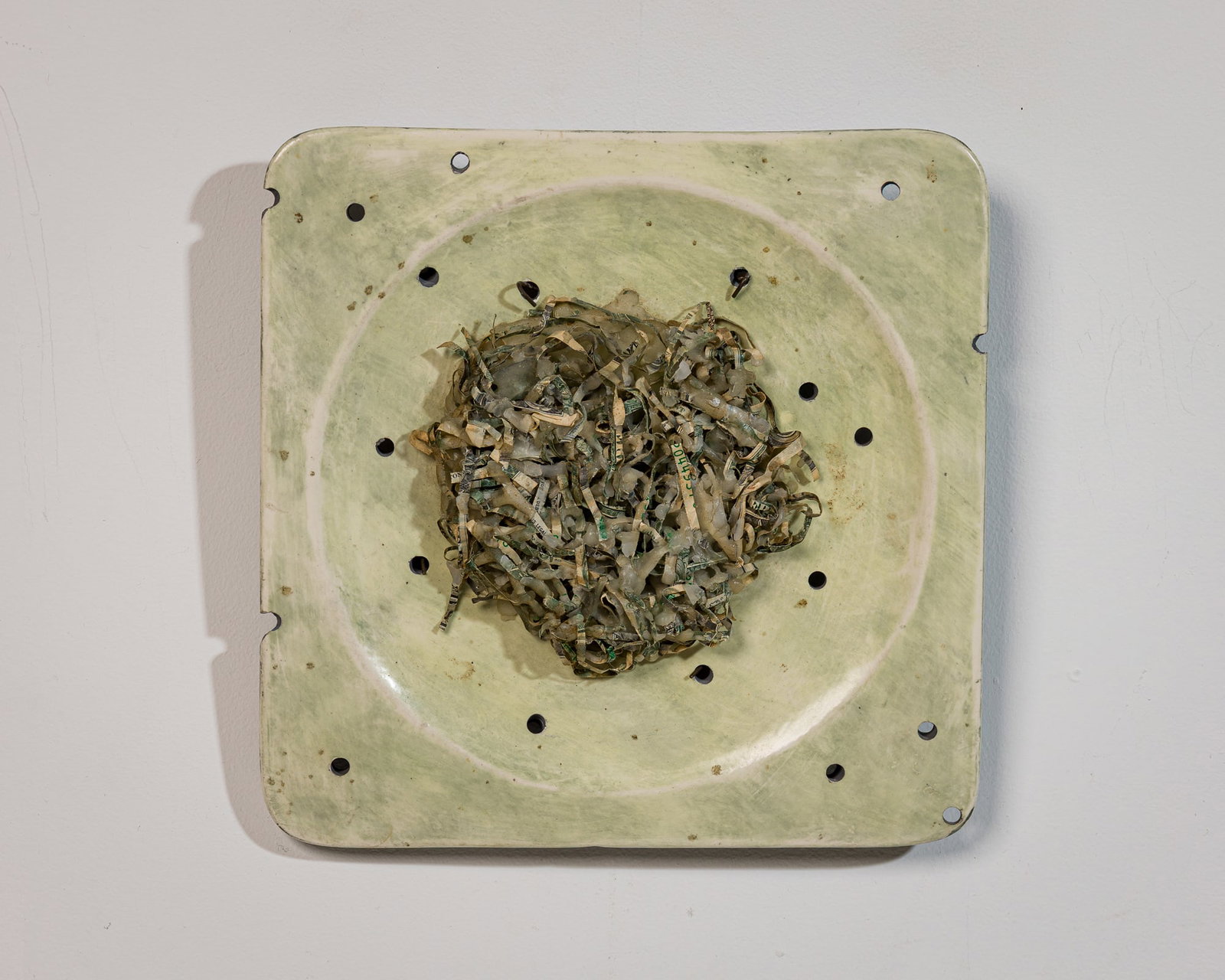 Yvon Guillaume, sculpture assemblage, 1999: Yvon Guillaume (French, active 20th c.), artist made ceramic plate, shredded US currency, and Wax, unsigned 1 ½ x 9 ½ x 9 ¾" Provenanc