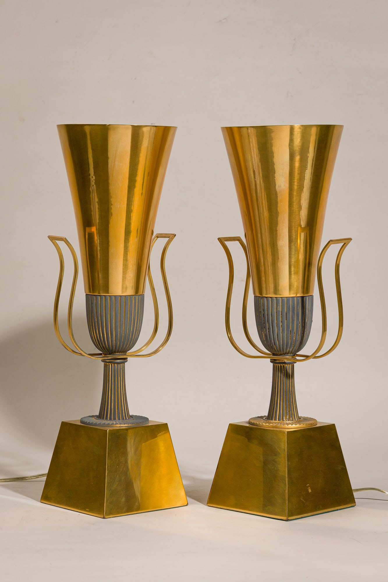 Tommi Parzinger for Lightolier, pair torchiere table lamps: c. 1950s, USA, tole sheet metal cone shades with custom gilt finish, Neoclassical urn-form base, internally wired with single standard socket, for Lightolier's Heritage Collection, 19.7