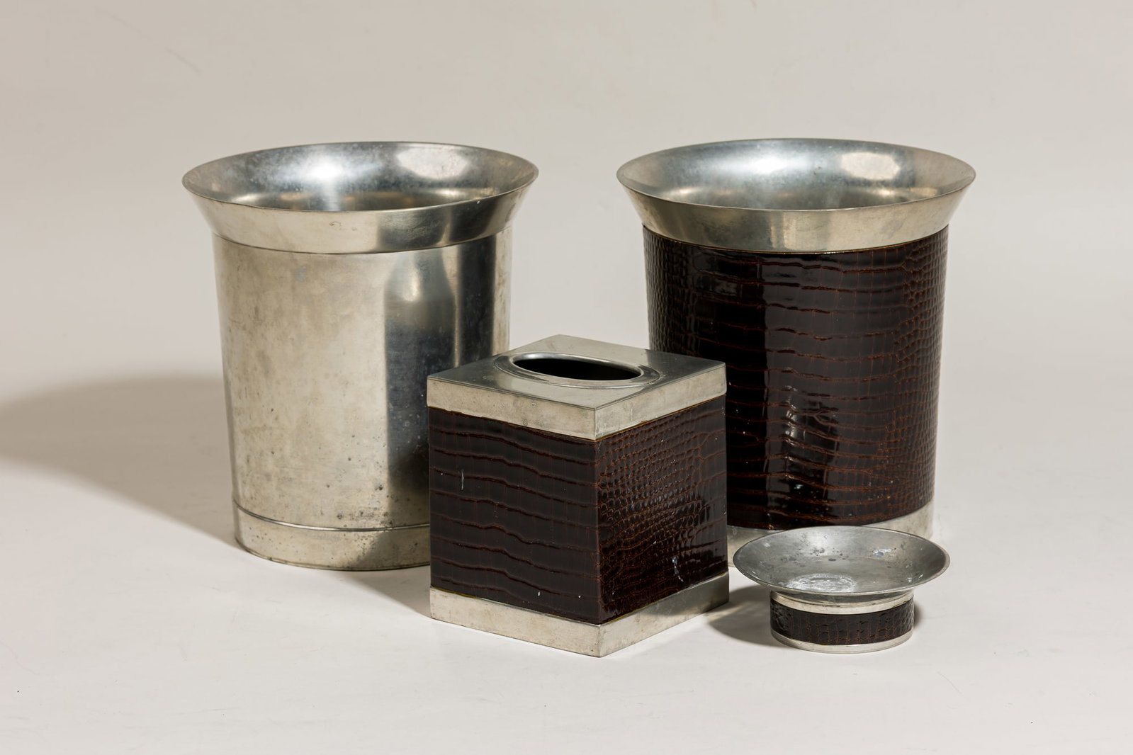 Labrazel, Art Deco style 4-piece pewter bathroom accessories set: late 20th c., Italy, faux-alligator leather, cast pewter, including 2 trash bins, 8.5"h x 8"dia, a tissue box cover, 5.5"h x 4.75"sqr, and a vide poche, 1.5"h x