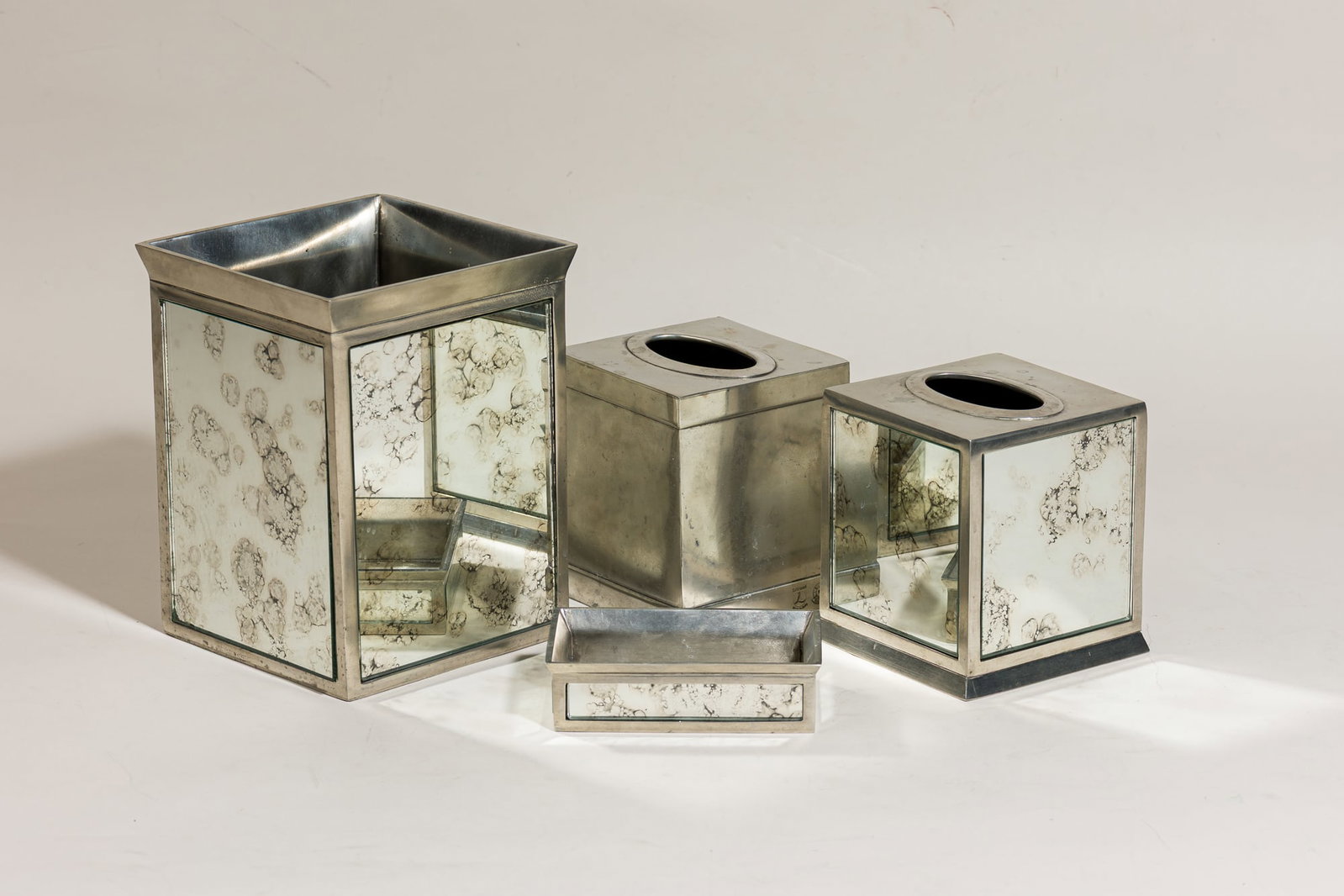 Labrazel, (4) piece Italian Modern pewter and mirrored glass bathroom accessories: late 20th c., Italy, cast pewter and antiqued mirror panels, including a wastepaper bucket, 8.5"h x 6.5” sqr, two tissue box covers, 5.5"h x 4.75"sqr, and one vide poche