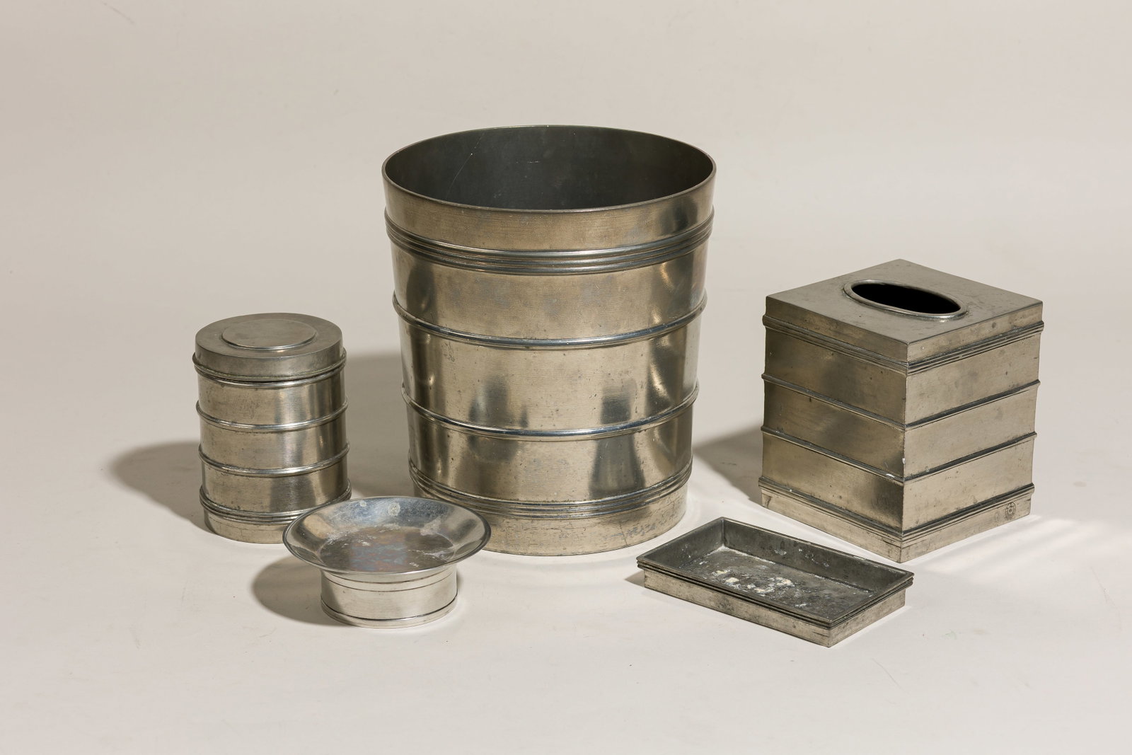 Labrazel, (5) Art Deco style pewter bathroom accessories: late 20th c., Italy, cast pewter, including a trash can, 8.5"h x 8"dia, a tissue box cover, 5.5"h x 4.75"sqr, a cotton ball container, 4.75"h x 3.5"dia, and two vide