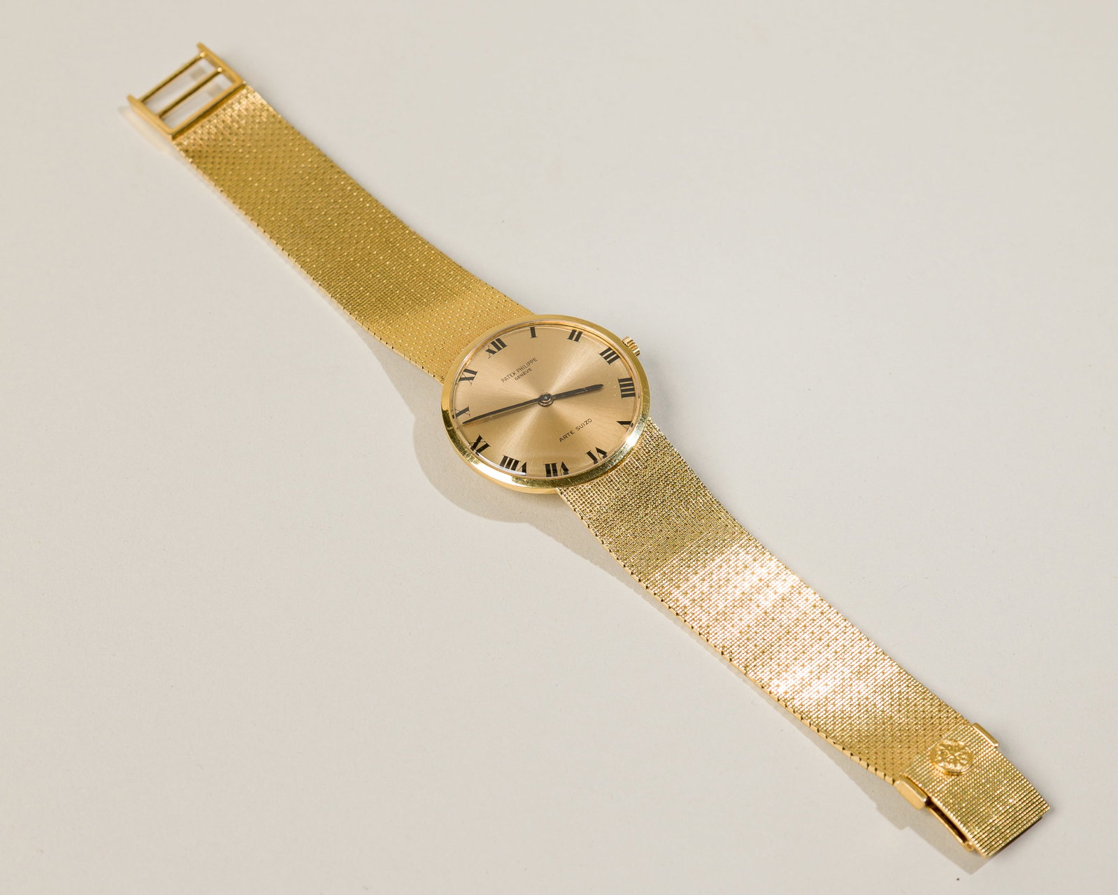 Patek Philippe 18K Yellow Gold Dress Watch: Circa: 1960 Dial: Champagne Case material: 18K yellow gold Bracelet material: 18K yellow gold Bracelet size: 7 1/2 inches Case dimensions: 33 mm in diameter Movement: Manual-Winding 