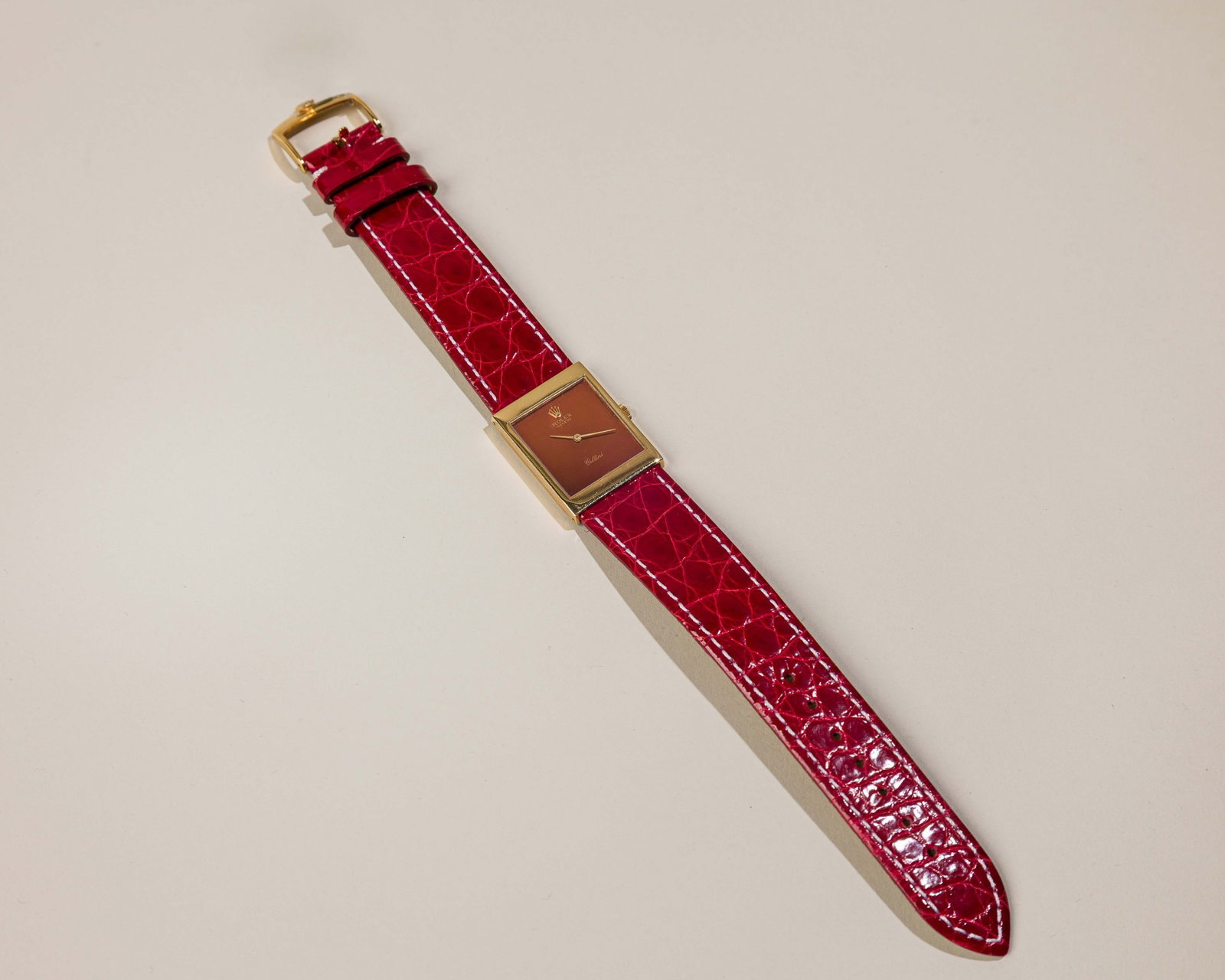 Rolex Cellini In 18K Yellow Gold With Red Mirror Dial: Type: Rolex,C`1973 Case Material: 18K yellow gold Case Dimensions: 22 mm wide x 29 mm top-to bottom Dial: Red mirror dial with Rolex coronet at the"12" hour marker Serial Number: 3241021 Ref
