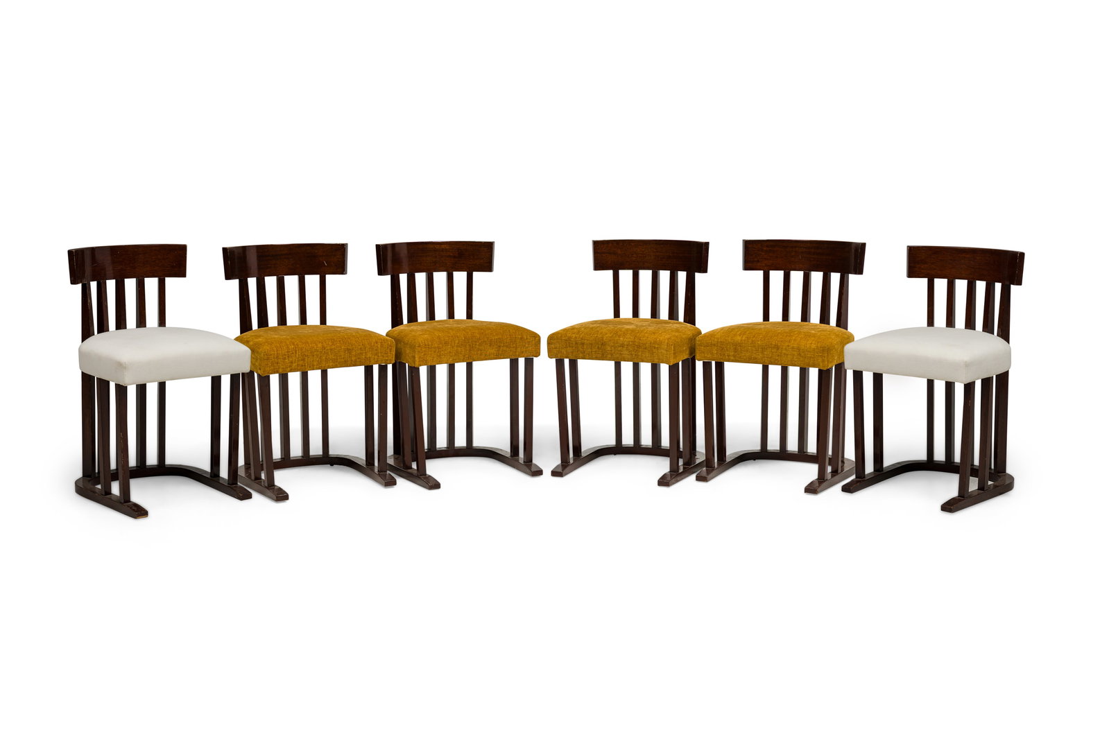 Josef Hoffman style, (6) mahogany side chairs: c. 1920s, likely Austria and in the Secessionist taste, mahogany frame with a slatted barrel-back design, four with yellow upholstered seat and two in white, 29.5"h x 17.75"w x 17"d