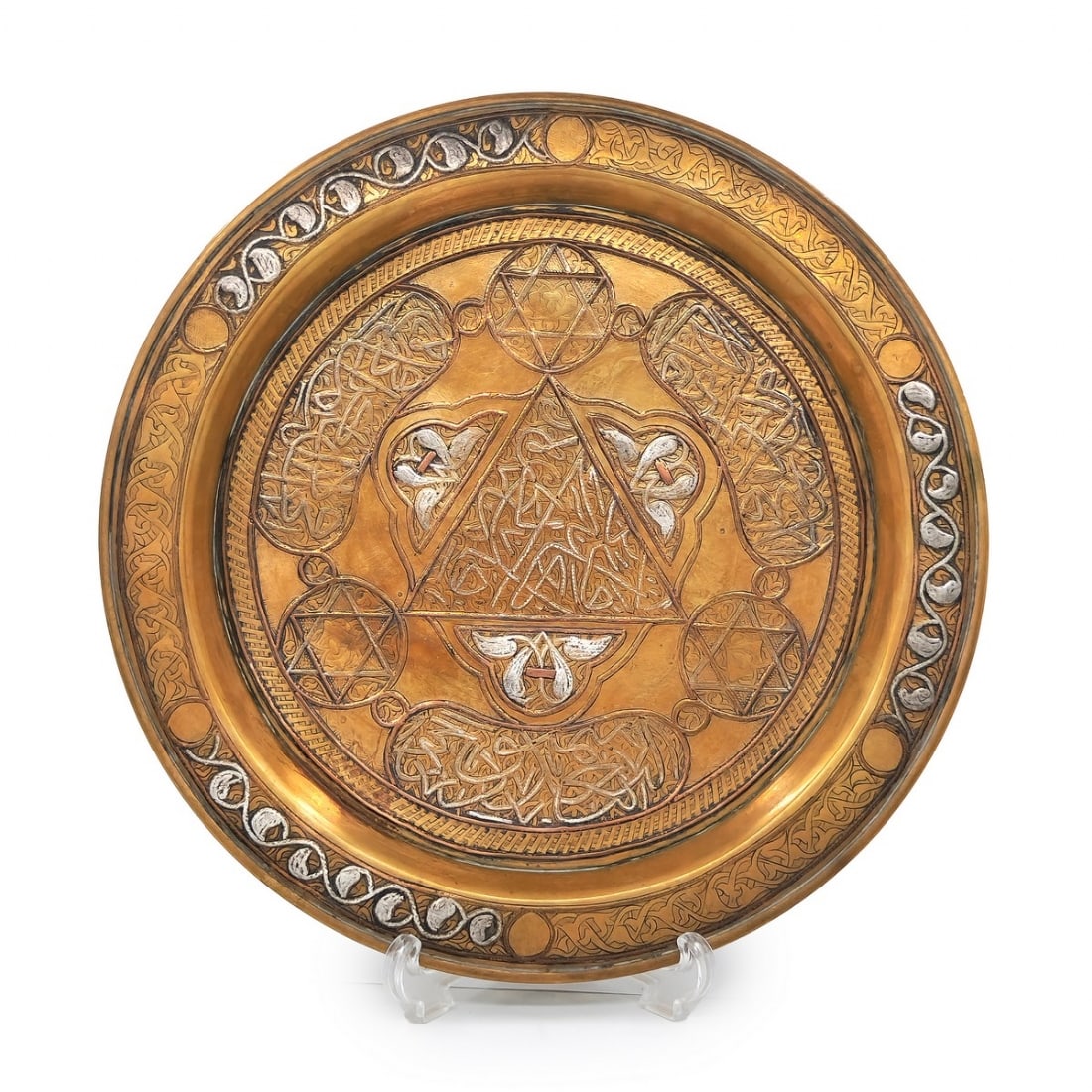An Islamic plate made of brass, decorated with 'Damascus work' inlay (1 of 2)
