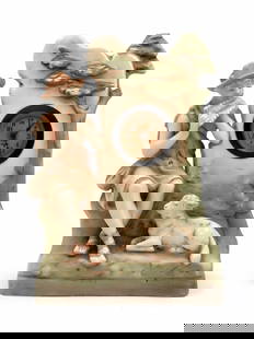 Antique Porcelain Mantel Clock Featuring a Shepherd Playing Pan Flute: Antique Porcelain Mantel Clock Featuring a Shepherd Playing Pan Flute, the clock face is signed. There is a chip on the back corner of the base. The working condition has not been tested. Height: 27