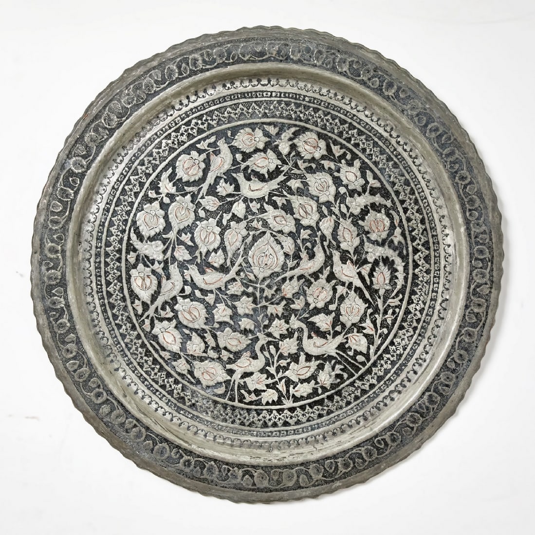 Large round Persian copper tray: Large round Persian copper tray, decorated with hand-hammered and engraved motifs, tin-plated. Fitted with a hanging loop on the back for wall display. Diameter: 59 cmNotice: We are located in Israel