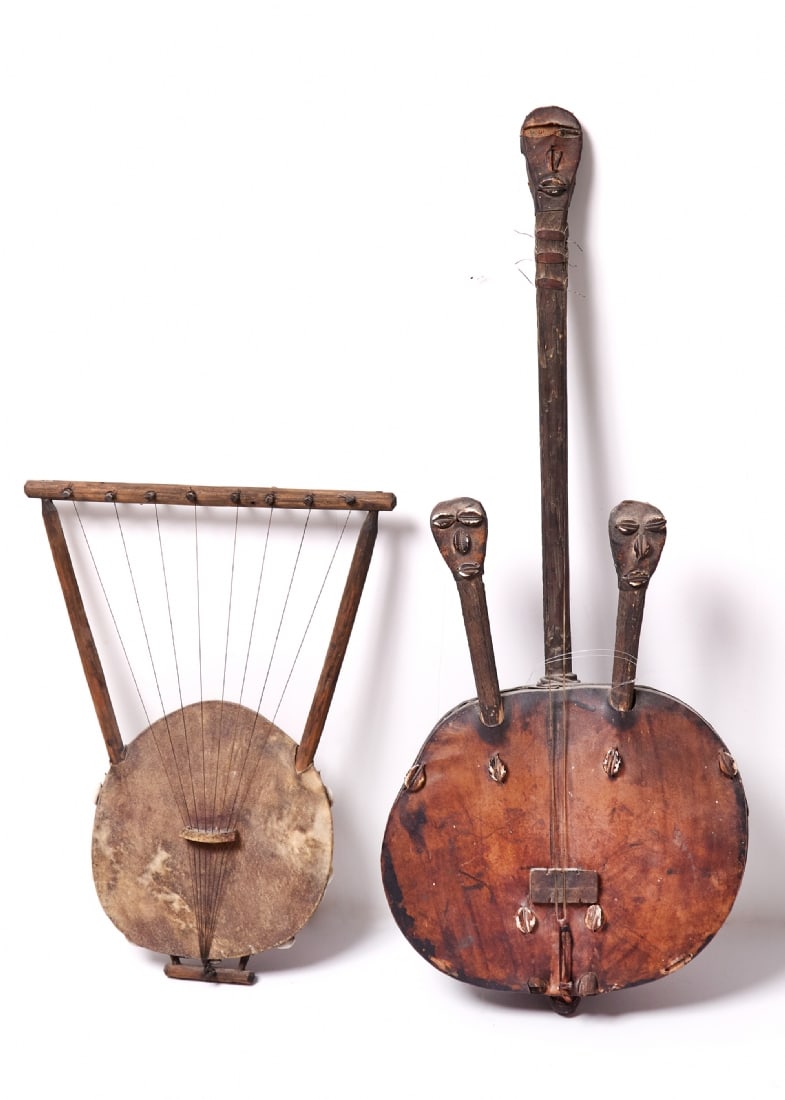 Two Traditional African Musical Instruments: Two Traditional African Musical Instruments, string instrument made of wood with cowrie shells – hand-carved wood, decorated with a row of cowrie shells along the body: 76 cm Endongo – traditional