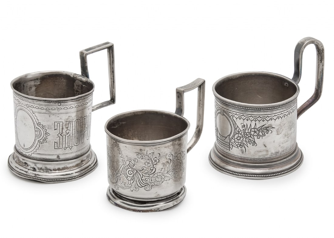 Three Antique Russian Tea Glass Holders Made of Silver: Three Antique Russian Tea Glass Holders Made of Silver, All are hand-decorated with delicate engravings and stamped, with different models and manufacturers. Two show signs of use and age (dents at