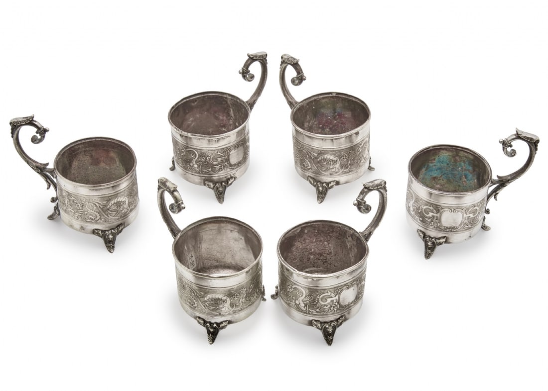 Six Silver-Plated Tea Glass Holders: Six Silver-Plated Tea Glass Holders, decorative metal structure with classic style handles Engraved decorations and small feet Width: 11 cm Height: 11 cm Notice: We are located in Israel and provide f