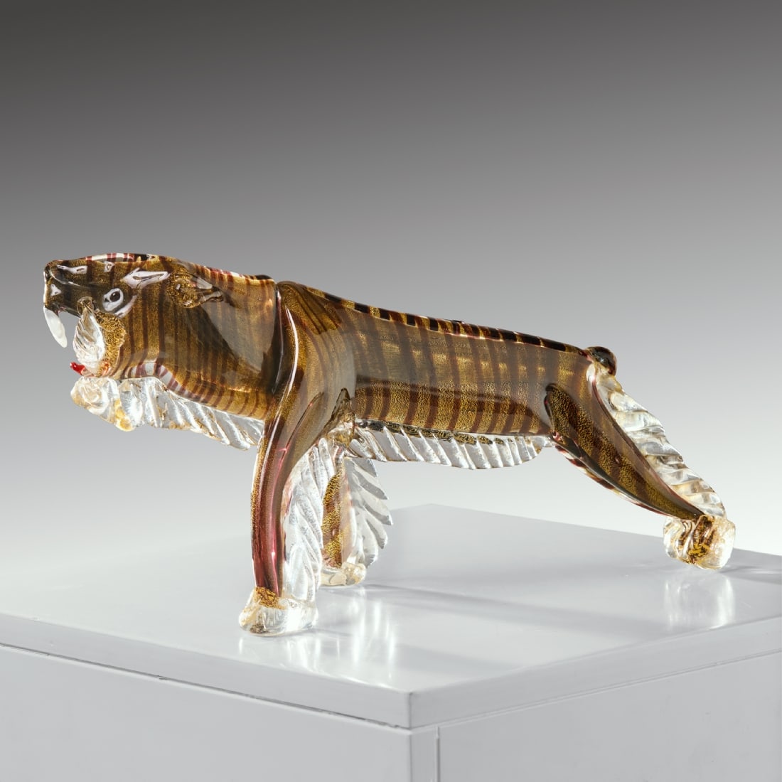Large Murano Glass Tiger Sculpture, Italy, 1940s-50s: Large Murano Glass Tiger Sculpture, Italy, 1940s-50s, made of glass with a black core, internal gold shimmer, and spiral glass threads Purple hue in the inner layer Tail is broken Dimensions: 38X13X20