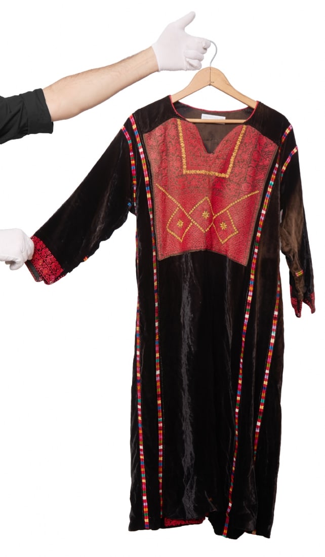 Palestinian Dress Made of Black Velvet with Hand-Embroidered Front: Palestinian Dress Made of Black Velvet with Hand-Embroidered Front, in traditional geometric patterns in shades of red and gold Length: 110 cm Notice: We are located in Israel and provide full