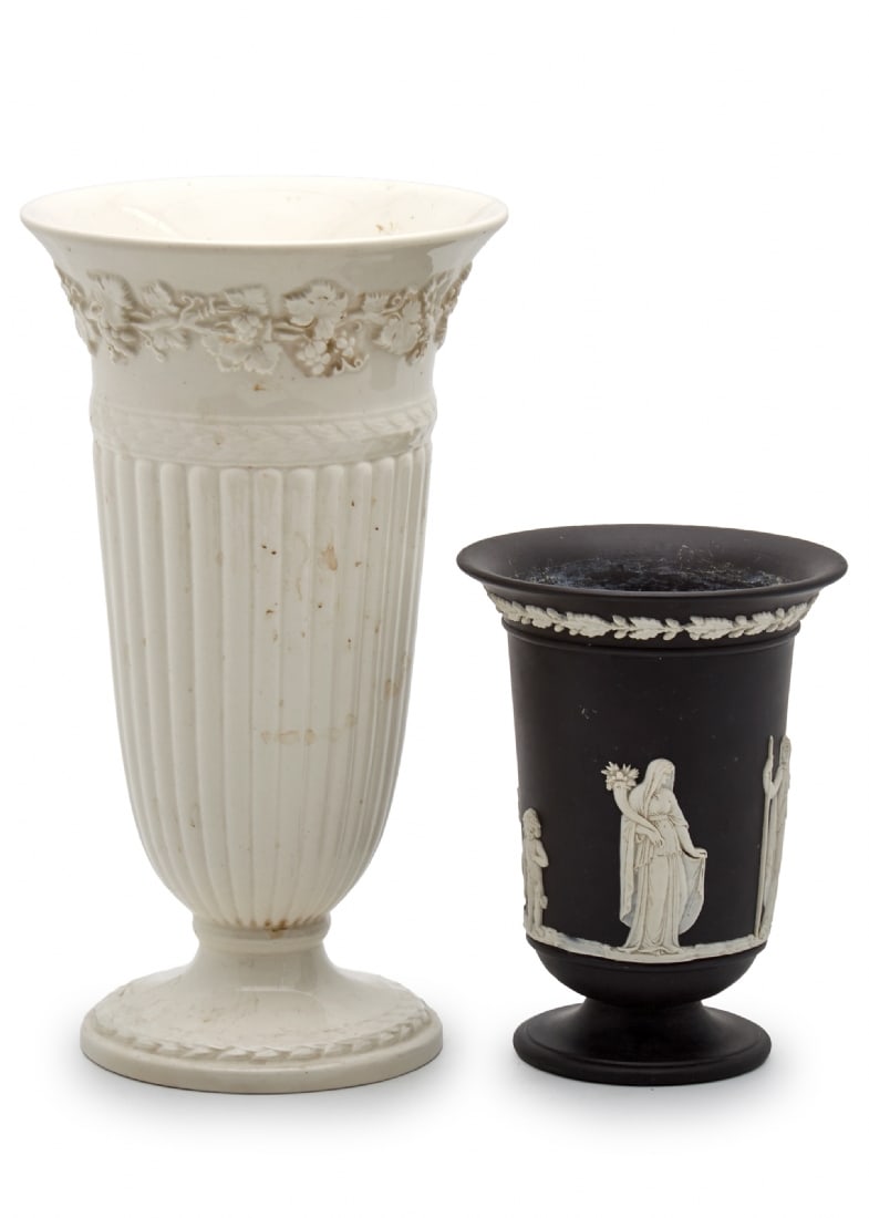 Pair of Goblet-Shaped Vases by Wedgwood: Pair of Goblet-Shaped Vases by Wedgwood, the first: Matte black vase Decorated with white classical figure reliefs in neo-classical style Height: 13 cm The second: Glossy cream vase Tall body with