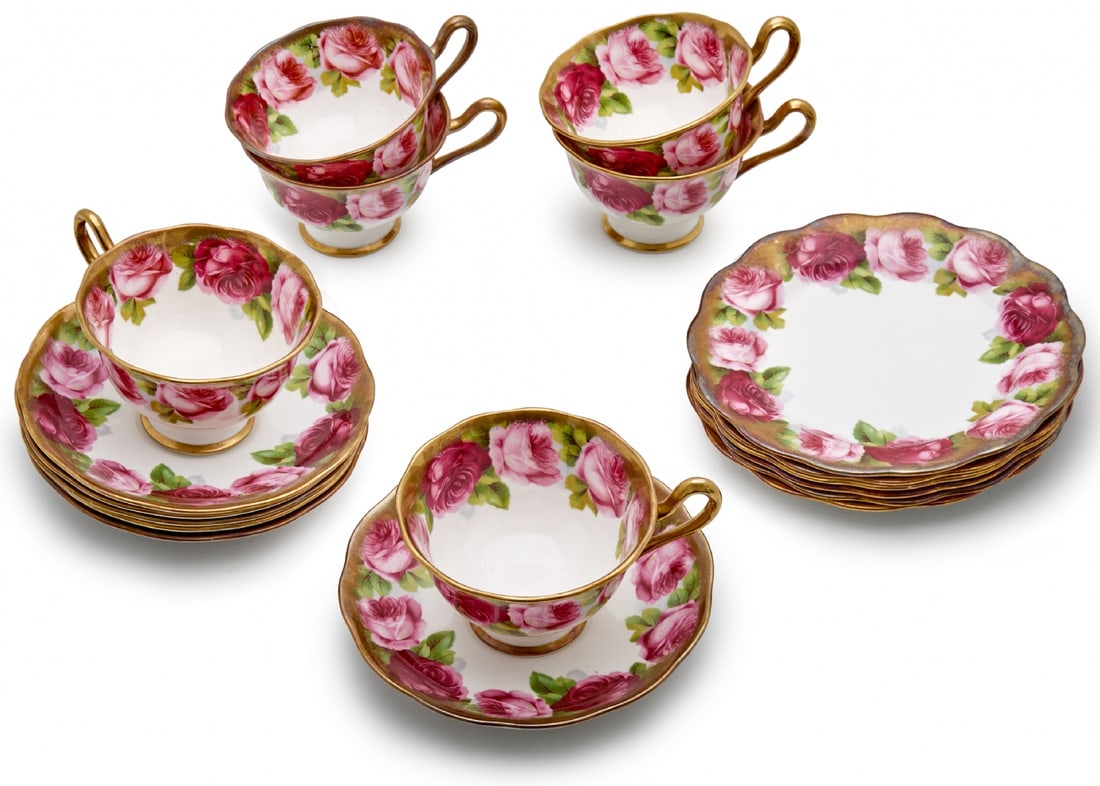 Tea Set by Royal Albert, Old English Rose Pattern: Tea Set by Royal Albert, Old English Rose Pattern, includes 6 trios – cup, saucer, and matching dessert plate. Rich rose decoration with gold rim Plate diameter: 14-16 cm Cup height: 7 cm Notice: We