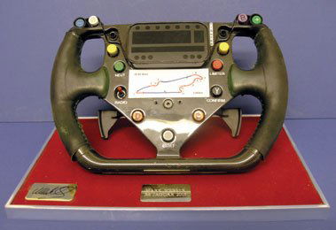 Mark Webber - The 2003 R4 Jaguar F1 Steering Wheel: This authentic and original steering wheel was used by Mark Webber during the 2003 Formula One season whilst he raced for Jaguar. It comes complete with wear marks to the grip, has the full set of wor