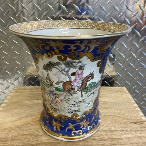 Andrea by Sadek Vintage Chinese Porcelain Vase: A beautifully crafted vintage Chinese porcelain vase by Andrea by Sadek. This piece features intricate hand-painted scenes of figures on horseback, surrounded by ornate blue and gold detailing. The ri