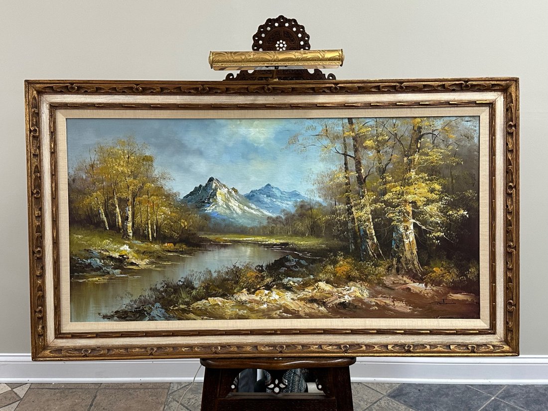 Oil on canvas Painting by Antonio!: An expansive oil painting featuring a serene river, lush forest, and majestic mountains, signed by Antonio. The framed dimensions measure approximately 56 inches in width and 32 inches in height, whil