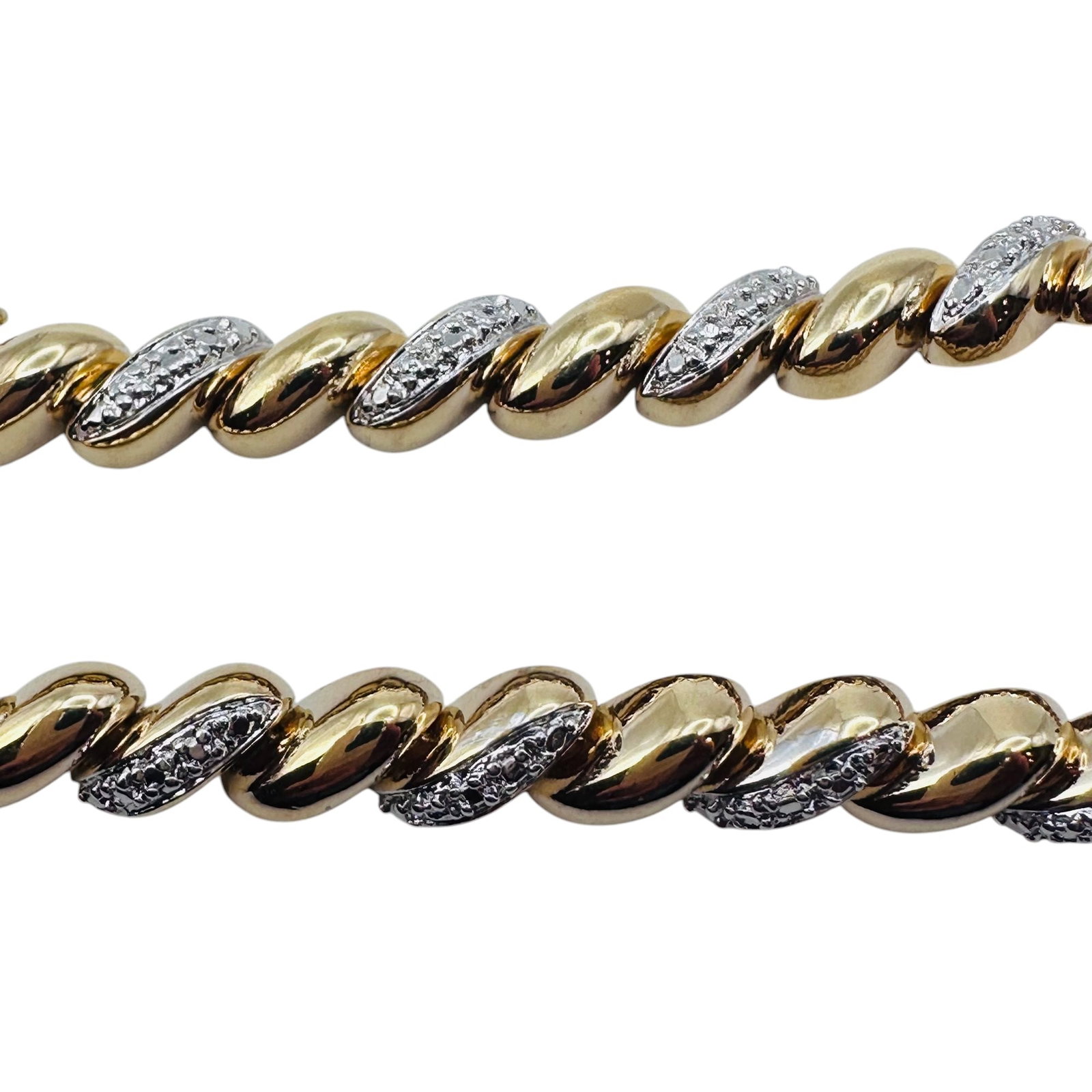 R Sterling Silver Gold Colored And Clear Stone Twist Bracelet. 16.84 G.: “R” sterling silver gold colored and clear stone twist bracelet. 16.84 g.