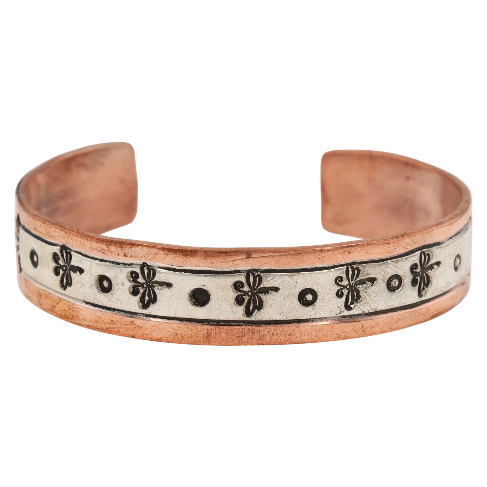 Charlene Little Navajo Sterling Silver and Copper Cuff Bracelet: A Navajo sterling silver and copper cuff bracelet by Charlene R. Little. The bracelet features a central applied band of sterling silver, decorated with regularly spaced, stylized dragonfly motifs alt